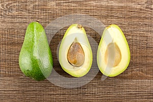 Fresh raw smooth avocado on brown wood photo