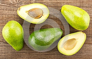 Fresh raw smooth avocado on brown wood photo