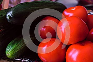 Green smooth cucumbers and red ripe tomatoes