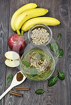 Green smoothie with apples, spinach, banana, germinated buckwheat and cinnamon