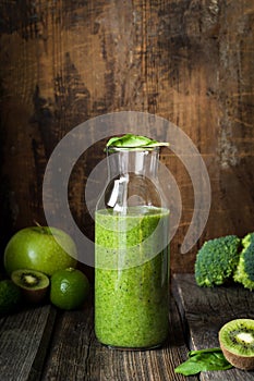Green smoothie bottle on wooden table