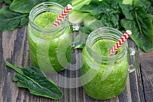 Green smoothie with celery, cucumber, spinach, apple, lemon