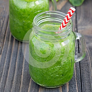 Green smoothie with celery, cucumber, spinach, apple and lemon, square
