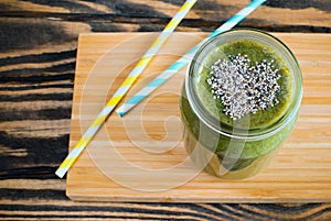 Green smoothie with chia seeds in a heart shape.