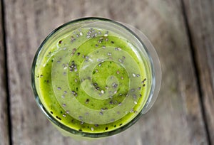 Green Smoothie drink in clear glass, topped with chia seeds