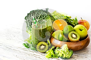 Green smoothie with fruits and vegetables copy space background