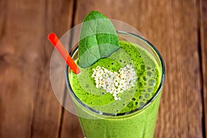 Green smoothie with heart of sesame seeds