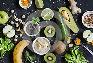Green smoothie ingredients. Cooking healthy detox smoothies. On a dark background
