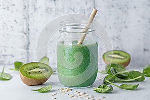 Green smoothie in jar on table