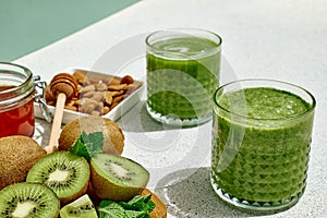 Green smoothie with kiwi fruit in the glasses. Healthy organic drink. Nutrition and alkaline diet. Healthie eating vegetarian