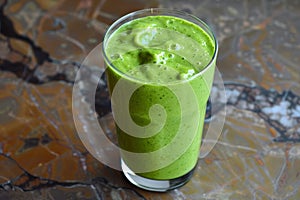 Green smoothie on a marble background