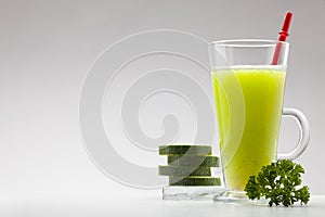 Green smoothie on white background with blank space for text