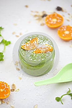 Green smothie with mandarine and granola.