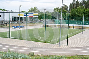 Green soccer field with blue seats. Sports stadium