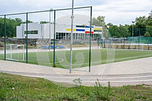 Green soccer field with blue seats. Sports stadium