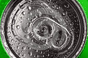 Green soda can top in water drops, closeup