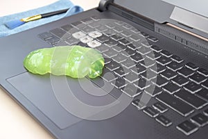 Green soft cleaning gel for cleaning dust on a laptop keyboard.