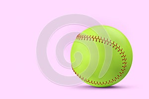 Green softball or baseball ball isolated on pink background.