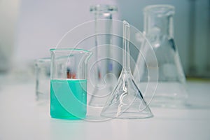 Green solution in glass beaker in science lab