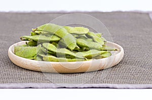 Green soybean Vegetable soybean boiled in wooden plate on blac