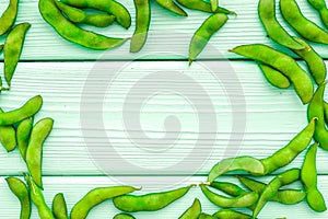 Green soybeans or edamame for fresh healthy food frame on mint green wooden background top view space for text