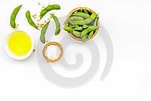 Green soybeans or edamame and oil for fresh healthy food on white background top view space for text