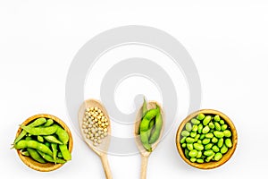 Green soybeans or edamame in spoon and bowl for fresh healthy food on white background top view space for text