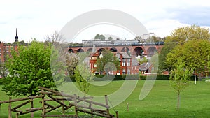 Green space in Stockport town. Train passing on viaduct