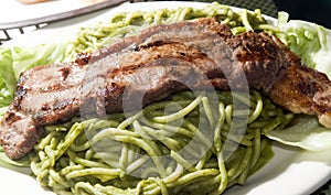 Green spaghetti tallarin saltado steak Peru photo