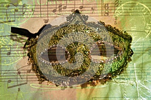 Green Sparkling Lace Opera Mask on Musical Notes Background