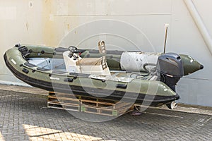 Green speedboat with a outboard motor