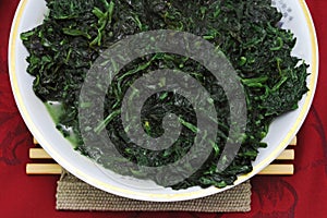 Green spinach dish on the red