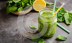 Green spinach smoothie. Green vegetable juice on rustic wood table. Blended green smoothie. Healthy breakfast with green smoothie