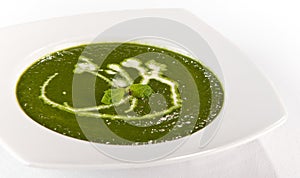 Green spinash soup with cream in a plate