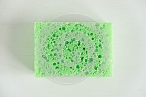 Green sponge for cleaning on a white background