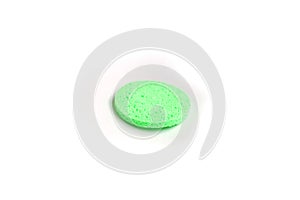 The green sponge lies on a white background photo