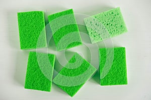 Green sponges for cleaning on a white background