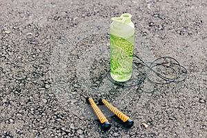 Green sports water bottle and sports jump rope