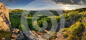 Green spring mountain landscape with sun and rocks - panorama