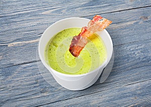 Green spring pea soup with bacon at blue wood