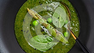 Green spring pureed asparagus soup in a bowl decorated with dill. Clean eating, dieting, vegan, vegetarian, healthy food concept