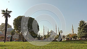 Green square with fountains near Sultan Ahmed Mosque Blue mosque in Istanbul, Turkey in a sunny day. 4K UHD video, 3840