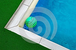 Green star ball floats in the pool