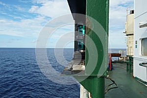 Green starboard side navigational lights of ship is situated next to superstructure.