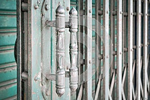 Green steel door handles of the old sliding door