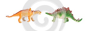 Green stegosaurus and orange pinacosaurus toy on white background