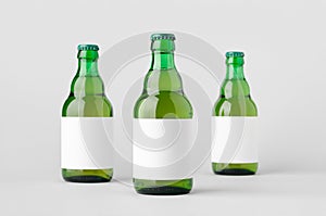 Green steinie beer bottle mockup with blank label