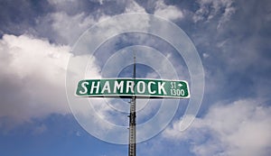 A green street sign for `Shamrock Street.