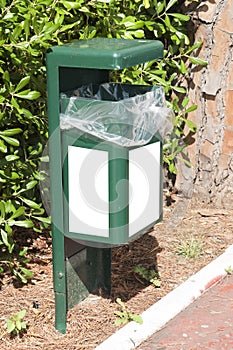 Green street trashbin with white labels for mockup photo
