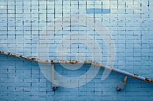 Green stucco wall texture with metal railing for background or copy space.